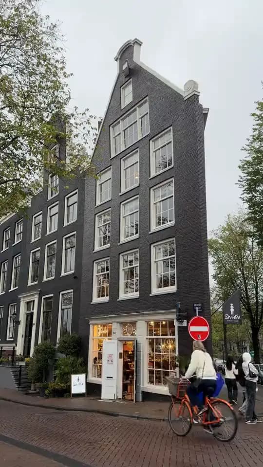 Canal house and cyclists